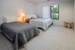 This bedroom has a queen and twin bed as well as attached full bath.
